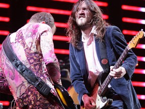 Bass player Flea (left) and guitarist John Frusciante of the Red Hot Chili Peppers perform for the crowd at Rexall Place in Edmonton. (File photo)