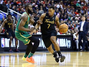 Celtics’ Jaylen Brown (left) defends against Raptors’ Kyle Lowry during their Christmas Day game at Scotiabank Arena. The broadcast on Sportsnet was the most-watched regular-season NBA game ever in Canada.