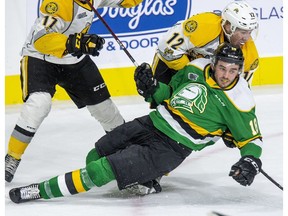 London Knight Liam Foudy keeps his eye on the play while being dumped by Nolan DeGurse of the Sarnia Sting during the first period of their game in London. (Free Press file photo)