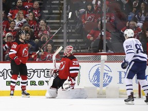 Damon Severson (left) and goaltender Mackenzie Blackwood of the New Jersey Devils react after losing 5-4 in overtime to the Toronto Maple Leafs at the Prudential Center on Friday night. (Bruce Bennett/Getty Images)