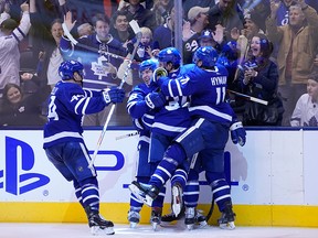 Toronto Maple Leafs defenceman Morgan Rielly and forward Mitch Marner and forward Auston Matthews and forward Zach Hyman celebrate a game-tying goal against the Carolina Hurricanes by Toronto Maple Leafs defenceman Tyson Barrie (not pictured) at Scotiabank Arena in Toronto on Monday, Dec. 23, 2019.
