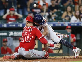 Jake Marisnick of the Houston Astros collides with catcher Jonathan Lucroy of the Los Angeles Angels of Anaheim as he attempts to score at Minute Maid Park on July 7, 2019 in Houston. (Bob Levey/Getty Images)