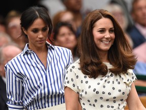 Britain's Catherine, Duchess of Cambridge, (R) and Britain's Meghan, Duchess of Sussex take their seats in the Royal box on Centre Court before watching Serbia's Novak Djokovic play against Spain's Rafael Nadal during the continuation of their men's singles semi-final match on the twelfth day of the 2018 Wimbledon Championships at The All England Lawn Tennis Club in Wimbledon, southwest London, on July 14, 2018.