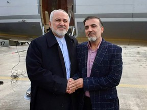 A handout picture released by the Iranian Foreign Minister's official Twitter account on  Saturday, Dec. 7, 2019, shows Foreign Minister Mohammad Javad Zarif (left) and Iranian scientist Massoud Soleimani standing by a plane at an undisclosed location.
