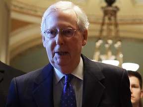 U.S. Senate Majority Leader Sen. Mitch McConnell (R-KY) (C) walks back to his office after he gave remarks in the Senate chamber Dec. 19, 2019 at the U.S. Capitol in Washington, D.C.