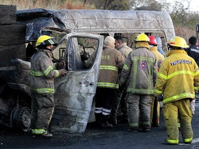 Firefighters work at the scene of an accident between a tourist van and a cargo truck on the Lagos de Moreno highway in Zapotlanejo, Mexico, on December 18, 2019. (ULISES RUIZ/AFP via Getty Images)