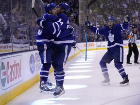 Maple Leafs forward Mitch Marner celebrates his game-winning goal against the Carolina Hurricanes with linemate Auston Matthews as defenceman Justin Holl gets set to join the party on Monday afternoon at Scotiabank Arena.