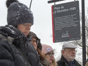 People attend the inauguration of a new sign at Dec. 6th Park commemorating the 30th anniversary of the 1989 Ecole Polytechnique attack where a lone gunman killed 14 female students Thursday, Dec. 5, 2019 in Montreal.