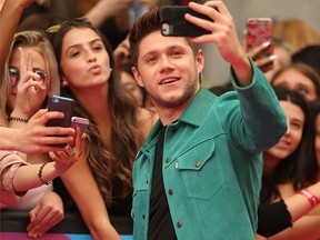 In this June 19, 2017, file photo, Niall Horan with the fans at the MMVA2017 on the pink carpet in Toronto.