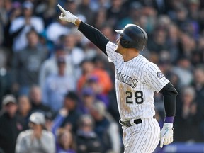 Nolan Arenado of the Colorado Rockies points to the crowd after hitting a home run against the Washington Nationals at Coors Field on September 30, 2018 in Denver. (Dustin Bradford/Getty Images)