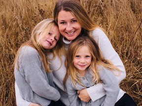 Sarah Cotton holds her daughters Chloe, left, and Aubrey Berry in October 2017 in this handout photo.