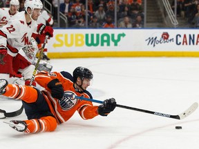 Edmonton Oilers centre Ryan Nugent-Hopkins is tripped by Carolina Hurricanes defenceman Brett Pesce during NHL action on Dec. 10, 2019, at Rogers Place.