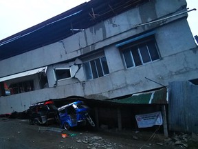 A destroyed house is seen with a vehicle squeezed underneath after a 6.8- magnitude earthquake in the town of Padada in Davao del Sur province on the island of southern Mindanao.