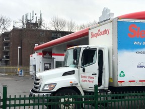 A delivery truck with a shattered window sits in a Richmond Hill gas station following a shooting Friday morning