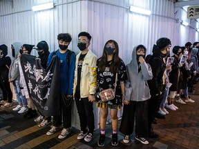 Protesters take part in a human chain rally at the Tsim Sha Tsui district of Hong Kong on Dec.  31, 2019.