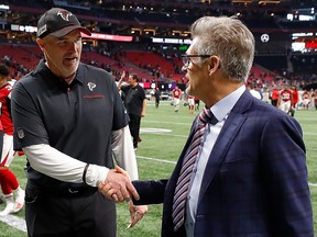 Head coach Dan Quinn and general manager Thomas Dimitroff shake hands after their 40-20 win over the Carolina Panthers at Mercedes-Benz Stadium on December 8, 2019 in Atlanta. (Kevin C. Cox/Getty Images)