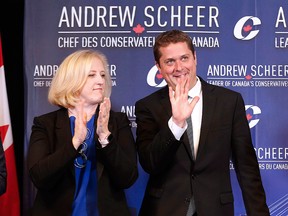 In this Sept. 6, 2017, file photo, Conservative Party Leader Andrew Scheer greets his shadow cabinet ministers, as Lisa Raitt look on, during a meeting in Winnipeg.