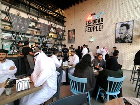 Women sit among men in a newly opened cafe in Khobar, Saudi Arabia, August 2, 2019.