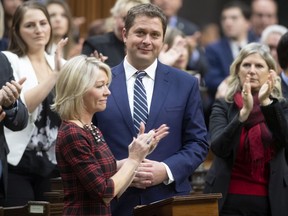 Leader of the Opposition Andrew Scheer is applauded by caucus members as he announces he will step down as leader of the Conservatives, Dec.12, 2019 in the House of Commons in Ottawa. (THE CANADIAN PRESS/Adrian Wyld)