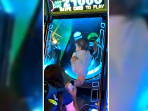 A viral video shows a toddler trapped under a pane of glass in a Skee Ball machine in Las Vegas. (Twitter)
