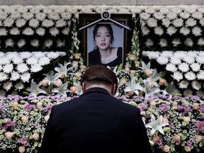 A man pays tribute at a memorial altar as he makes a call of condolence in honour of the K-pop star Goo Hara at the Seoul St. Mary's Hospital in Seoul, South Korea November 25, 2019.