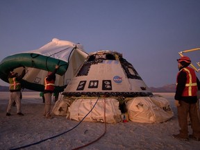 A protective tent is placed over the Boeing CST-100 Starliner spacecraft, which had been launched on a United Launch Alliance Atlas V rocket, after its descent by parachute following an abbreviated Orbital Flight Test for NASA's Commercial Crew programs in White Sands, New Mexico, U.S. December 22, 2019.