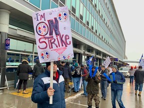 Unionized employees of Swissport Fueling picket outside Trudeau Airport in Dorval, west of Montreal, Tuesday Dec. 31, 2019.