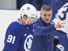 Head coach Sheldon Keefe (right) and captain John Tavares talks at Maple Leaf practice at the Ford Performance Centre.