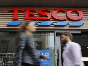 In this file photo taken on September 30, 2019 people walk past at a Tesco Express in central London. (TOLGA AKMEN/AFP via Getty Images)