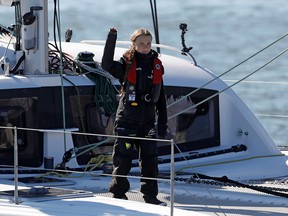 Climate change activist Greta Thunberg waves as she arrives aboard the yacht La Vagabonde at Santo Amaro port in Lisbon, Portugal December 3, 2019. (REUTERS/Pedro Nunes)