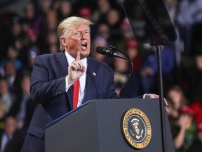 U.S. President Donald Trump reacts while speaking during a campaign rally in Battle Creek, Michigan, U.S., December 18, 2019.