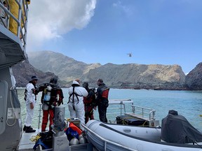 Members of a dive squad conduct a search during a recovery operation around White Island, which is also known by its Maori name of Whakaari, a volcanic island that fatally erupted earlier this week, in New Zealand, Dec. 13, 2019 in this handout photo supplied by the New Zealand Police.