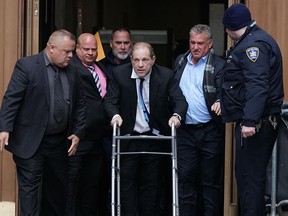 In this file photo taken on Dec. 11, 2019 Harvey Weinstein leaves Manhattan Criminal Court, using a walker, following a hearing in New York.