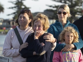 Locals gather to wave off the Ovation of the Seas cruise ship, which carried passengers who travelled to White Island when it erupted, in the Port of Tauranga on December 11, 2019 in Tauranga, New Zealand. (John Boren/Getty Images)