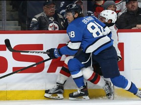 Winnipeg Jets defenceman Nathan Beaulieu (left) rubs out New Jersey Devils forward Taylor Hall in Winnipeg on Tues., Nov. 5, 2019. Beaulieu was penalized for interference.