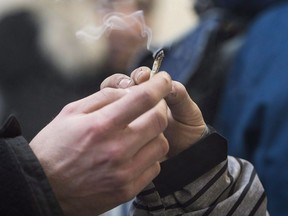 Two men pass a marijuana joint at Cannabis Culture in Montreal, Friday, December 16, 2016.