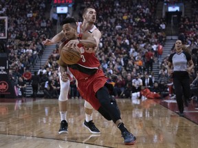 Portland Trail Blazers guard CJ McCollum drives to the basket as Toronto Raptors guard Matt Thomas defends during Tuesday's game.