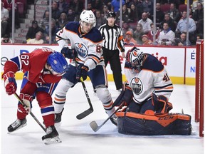 Goaltender Mike Smith of the Edmonton Oilers makes a pad save near teammate Caleb Jones #82 and Artturi Lehkonen #62 of the Montreal Canadiens during the second period at the Bell Centre on Jan. 9, 2020 in Montreal.