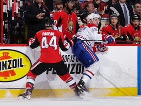 Jean-Gabriel Pageau #44 of the Ottawa Senators checks Jesperi Kotkaniemi #15 of the Montreal Canadiens along the boards in the second period at Canadian Tire Centre on January 11, 2020 in Ottawa, Ontario, Canada.