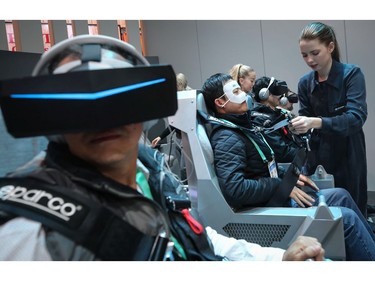 Attendees use virtual reality headsets to experience Hyundai and Uber's air taxi, S-AI, at CES 2020 at the Las Vegas Convention Center on Jan. 8, 2020, in Las Vegas.