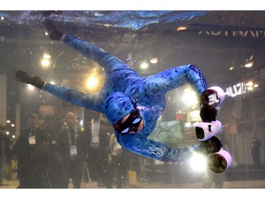 A model demonstrates Sublue's White Mix Pro, a smart electric underwater scooter, during CES 2020 at the Las Vegas Convention Center on Jan. 8, 2020, in Las Vegas.