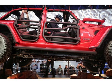 An attendee wears a virtual reality headset while riding in a show version of a 2020 Jeep Wrangler Unlimited 4xe plug-in hybrid electric vehicle at CES 2020 at the Las Vegas Convention Center 
in Las Vegas on Jan. 8, 2020.