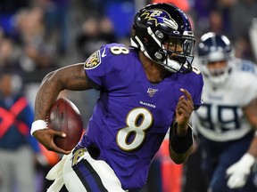 Quarterback Lamar Jackson of the Baltimore Ravens carries the ball against the defense of the Tennessee Titans during the AFC Divisional Playoff game at M&T Bank Stadium on January 11, 2020 in Baltimore, Maryland.