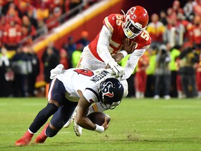 Quarterback Deshaun Watson of the Houston Texans is tackled by Frank Clark of the Kansas City Chiefs during the AFC Divisional playoff game.
