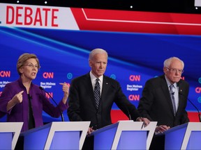 Sen. Elizabeth Warren (D-MA) speaks as former Vice President Joe Biden, centre, and Sen. Bernie Sanders (I-VT) listen during the Democratic presidential primary debate at Drake University on Jan. 14, 2020 in Des Moines, Iowa.  (Scott Olson/Getty Images)