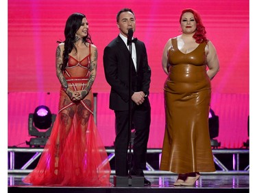 (L-R) Adult film actress/director Joanna Angel, AVN Media Network CEO Tony Rios and adult film actress/director April Flores present an award during the 2020 Adult Video News Awards at The Joint inside the Hard Rock Hotel & Casino on Jan. 25, 2020, in Las Vegas.