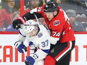 Yanni Gourde of the Tampa Bay Lightning battles against Mark Borowiecki of the Ottawa Senators during the second period at the CTC on Saturday, Jan. 4, 2020.