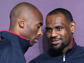 LeBron James watches, as Kobe Bryant walks into the room during a press conference ahead of the London 2012 Olympics on July 27, 2012 in London, England.
