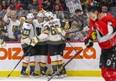 Vegas Golden Knights winger Mark Stone (centre) is congratulated after scoring a wrap-around goal against the Senators on Thursday night. (WAYNE CUDDINGTON/Postmedia Network)