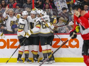 Vegas Golden Knights winger Mark Stone (centre) is congratulated after scoring a wrap-around goal against the Senators on Thursday night. (WAYNE CUDDINGTON/Postmedia Network)